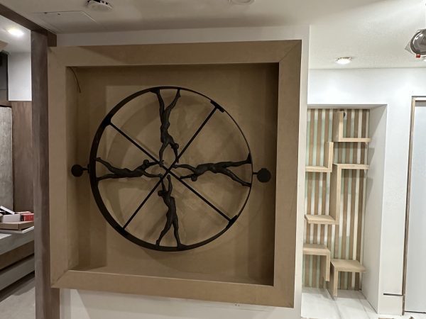 Custom recessed wall niche with sculptural metal artwork during interior renovation by Delghavi Design in Ontario