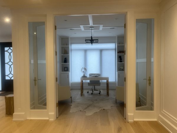 “Luxury home office in Aurora with custom glass double doors, built-in shelving, white MDF trim work, and modern ceiling detailing — premium renovation by Delghavi Design & Build.”