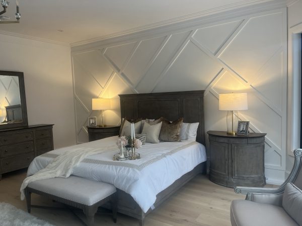 Custom bedroom feature wall with accent wall paneling, and modern nightstands by Delghavi Design & Build