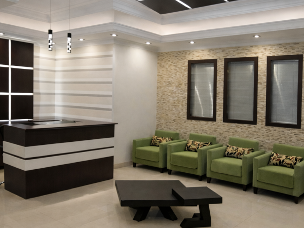 office waiting room with custom LED reception desk, and contemporary seating renovation in the by delghavi design and build